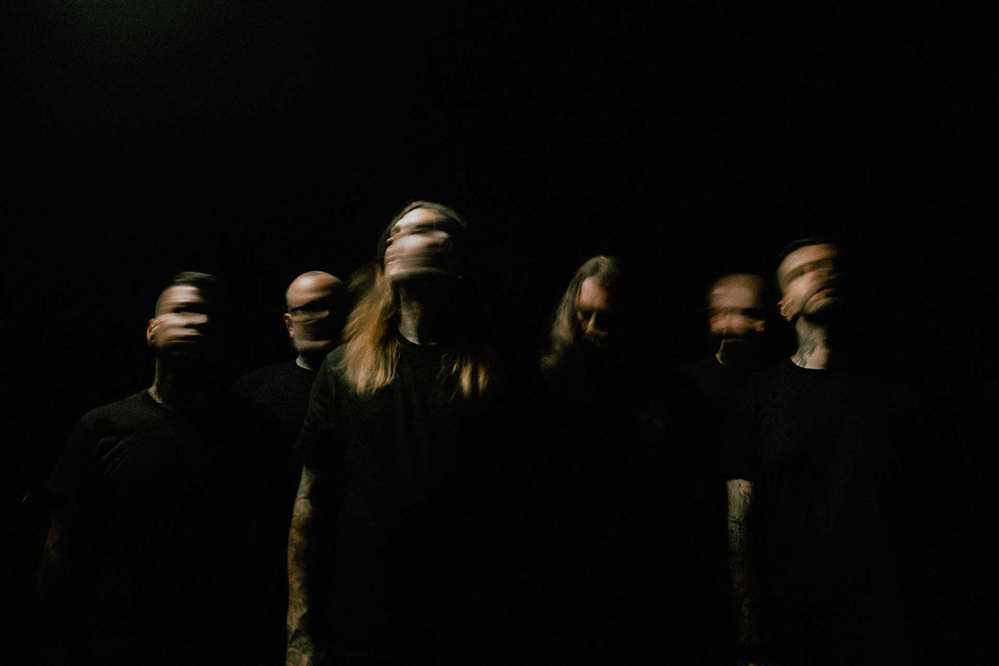 Fit For An Autopsy Promo Photo - Band members in all black with motion blur faces